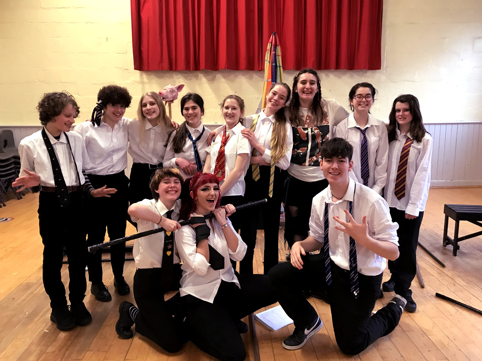 Group shot of the 2022 yout theatre group posing in their stage costumes.